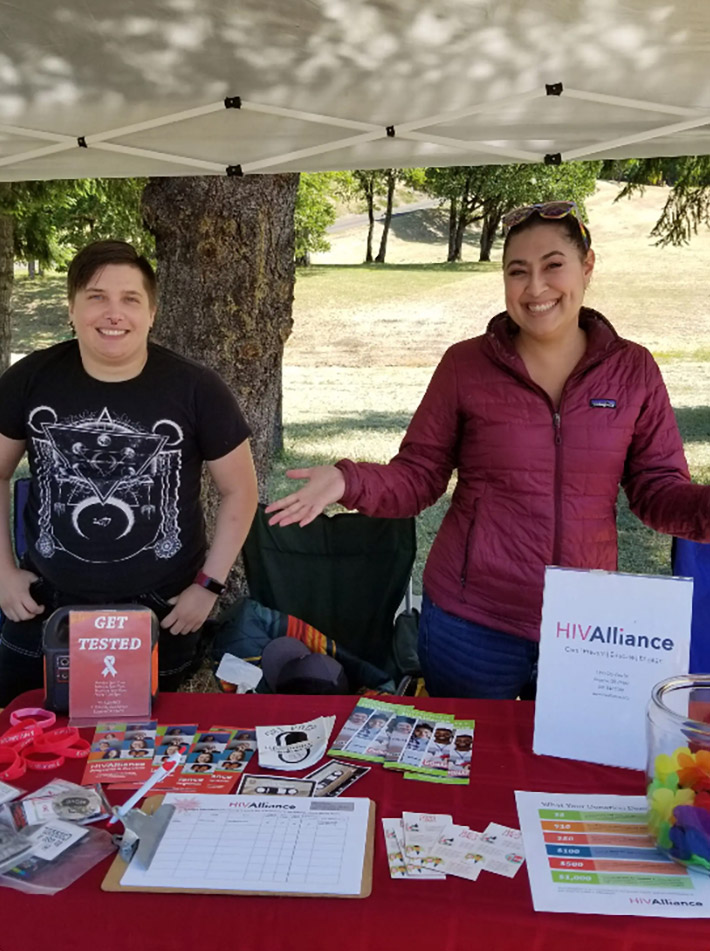 photo of two people answering questions at a car show like, "how do people get HIV?"