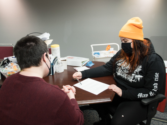 photo of a worker helping with medication consultation for hiv treatment