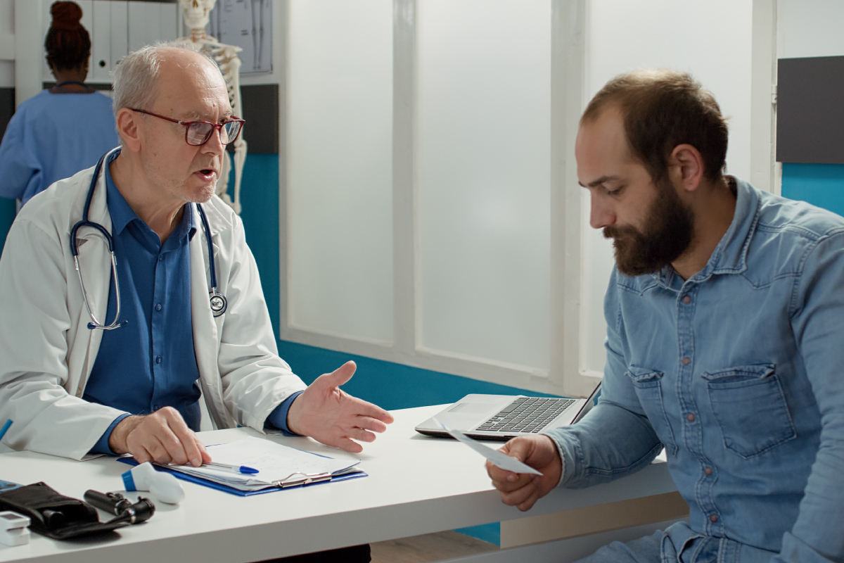 photo of a doctor and patient discussing hepatitis C transmission